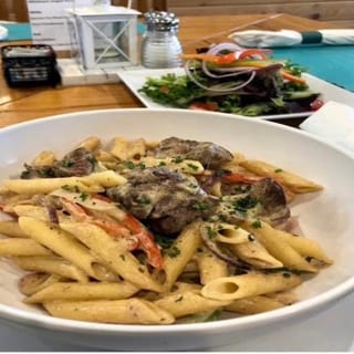 Grass Fed Filet Tips, Penne Pasta, Sauteed Peppers & Onions with Cajun Cream Sauce, Side Salad